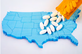 Pill bottle spilling pills onto a United States map