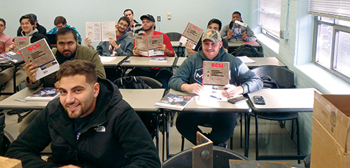 Students holding their BCSI book