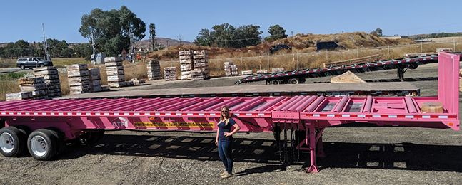 Ashley standing in front of her pink trailer