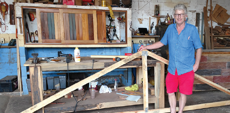 David Johnson standing next to a roof truss